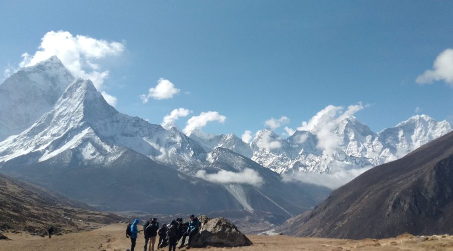 people in front of a mountain range