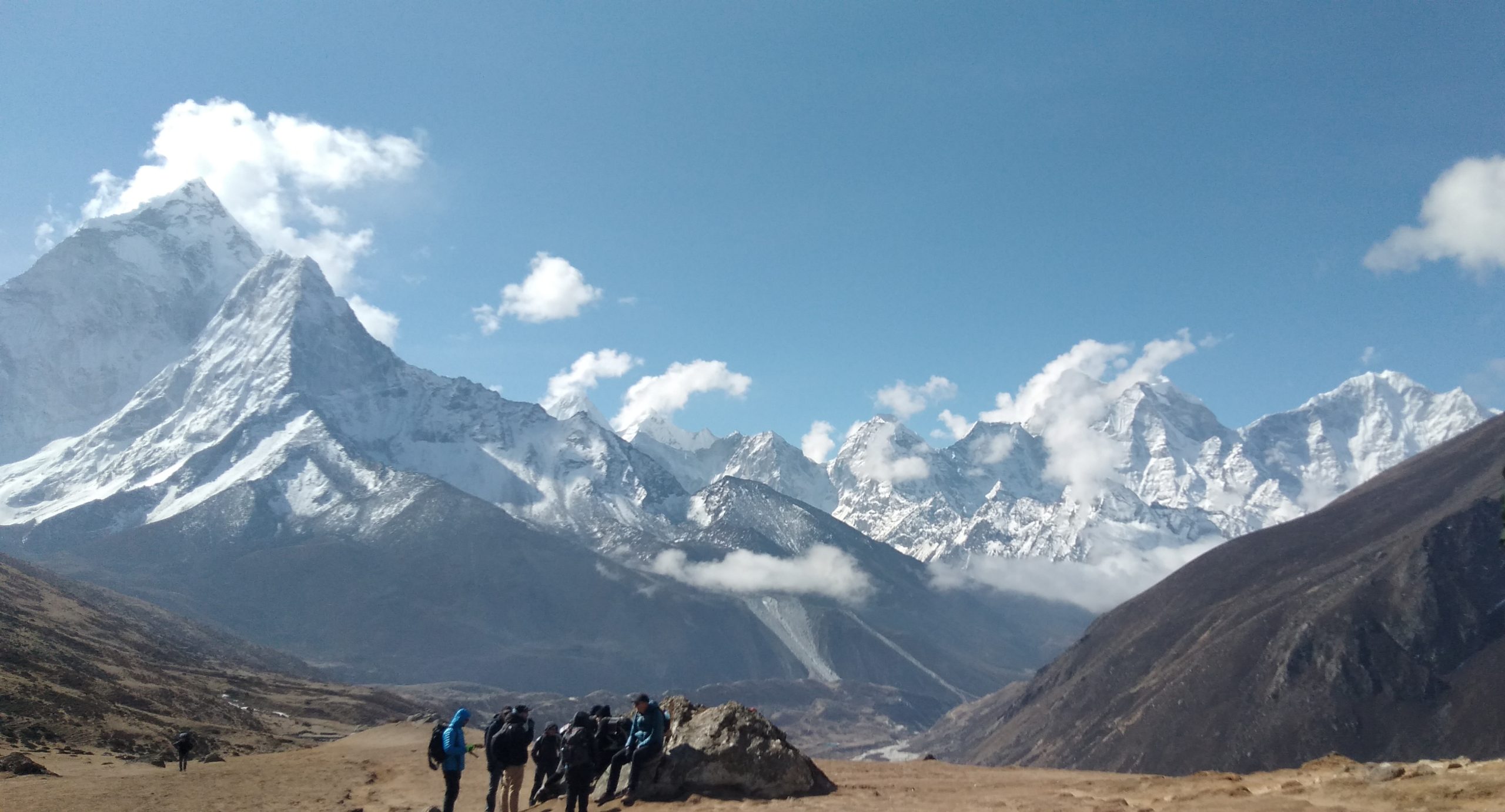 people in front of a mountain range